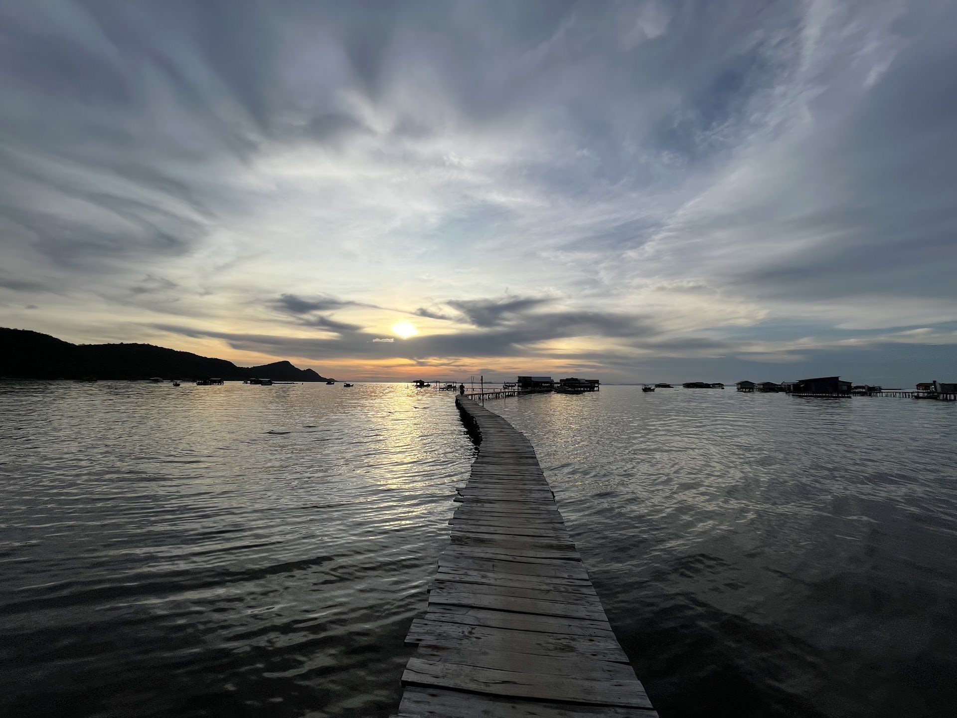 Wooden jetty running out over calm water at sunset on Phu Quoc