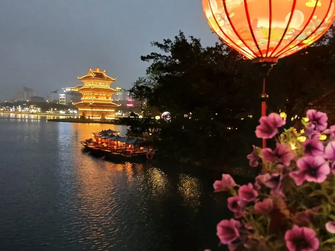 Traditional Vietnamese Buddhist Pagoda Illuminated at Night With Golden Roof Curved Eaves and Traditional Architecture Similar to Hoa Lu Bai Dinh Temple Complex Ninh Binh. This is in Ninh Binh city center