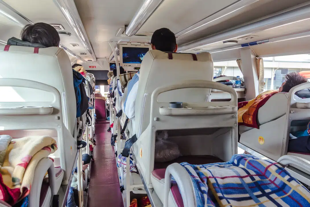 Two tiers of reclined berths inside a Vietnamese sleeper bus