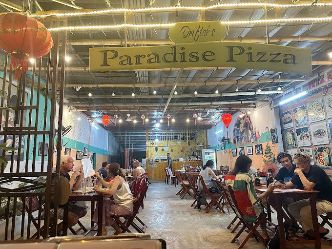 Interior of Drifter S Paradise Pizza Restaurant With Customers Dining Under Warm Lighting and Red Lanterns