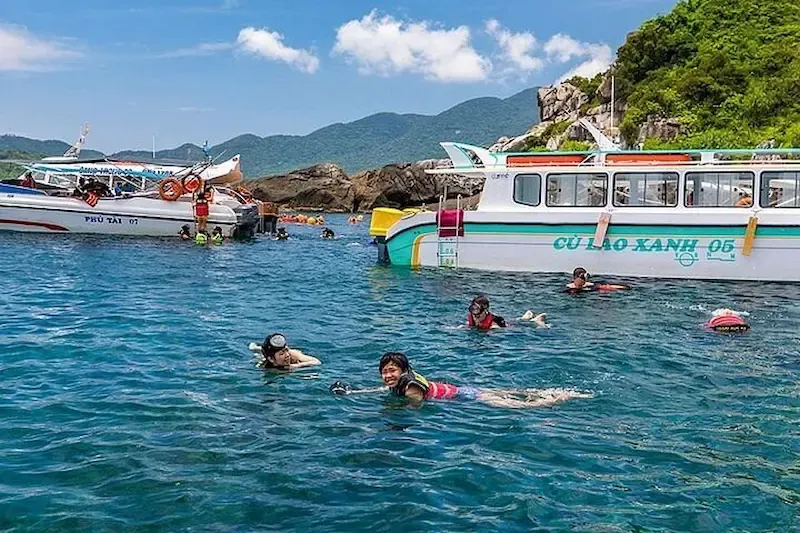 Vietnamese Tourists Relaxing at a Stop During Cham Island Adventure Tour