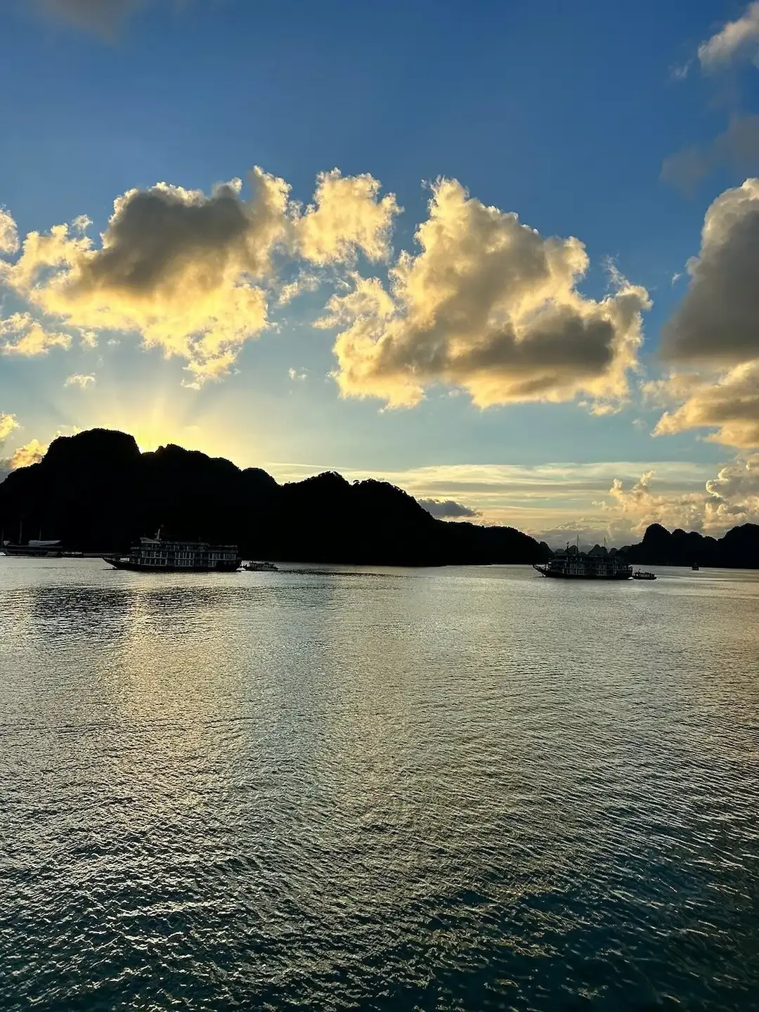 Lan Ha Bay Vietnam at Golden Hour With Dramatic Clouds, Blue Sky and Cruise Boats on Tranquil Water