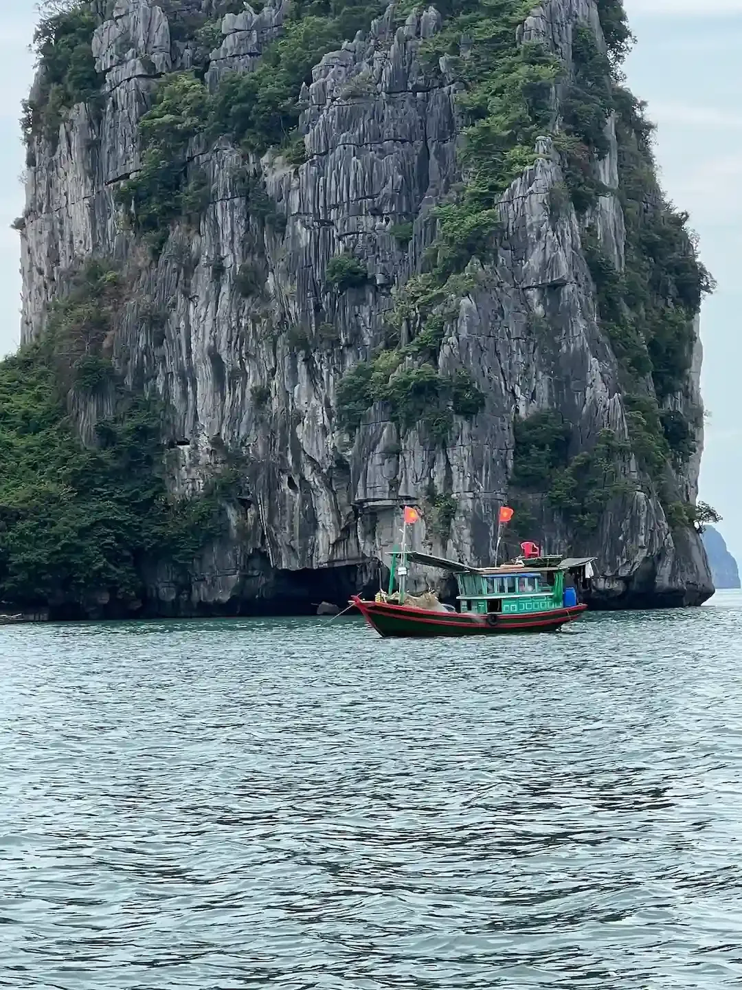 Dramatic Limestone Cave Formation at Bai Tu Long Bay With Colorful Fishing Boats Anchored Inside Cavern   Authentic Fishing Village and Natural Wonder