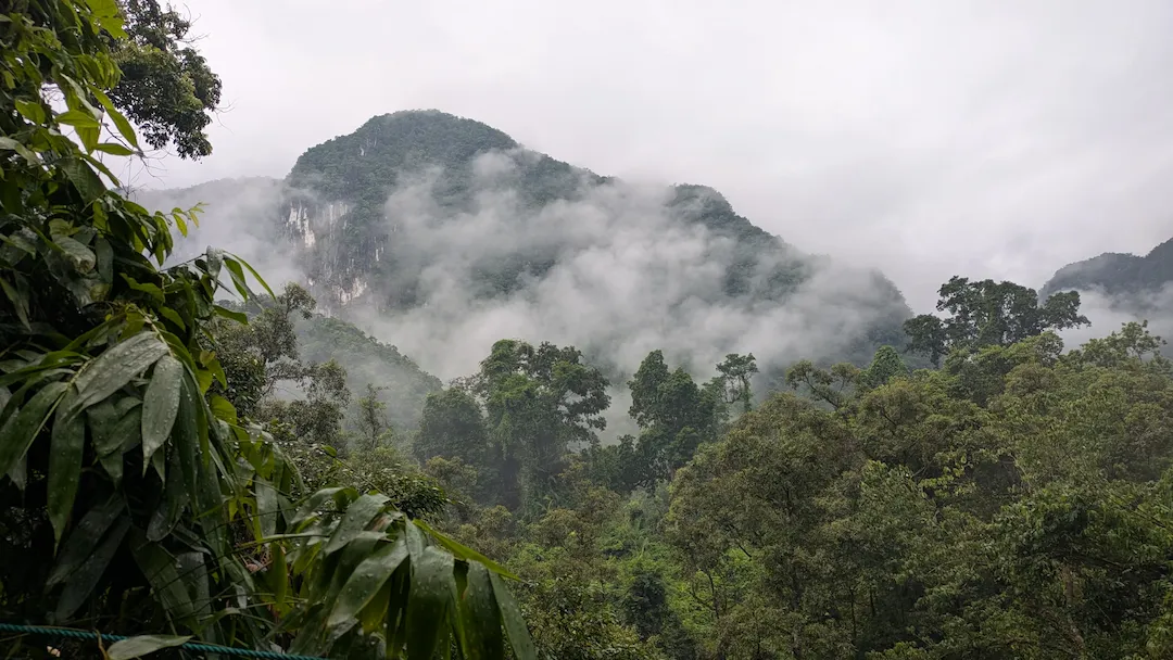 Cloud sitting on the limestone peaks above Phong Nha