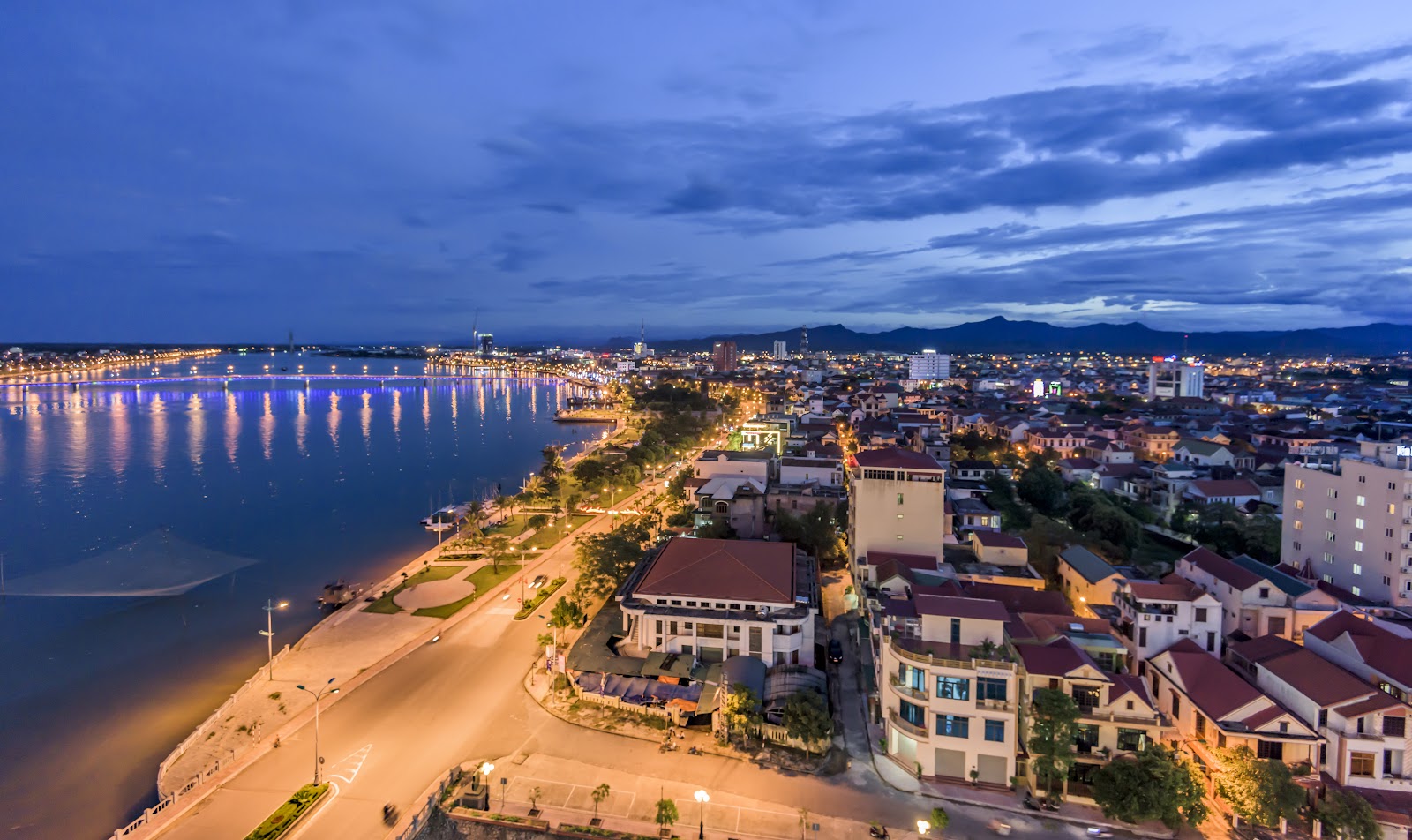Dong Hoi and the Nhat Le river lit up at dusk