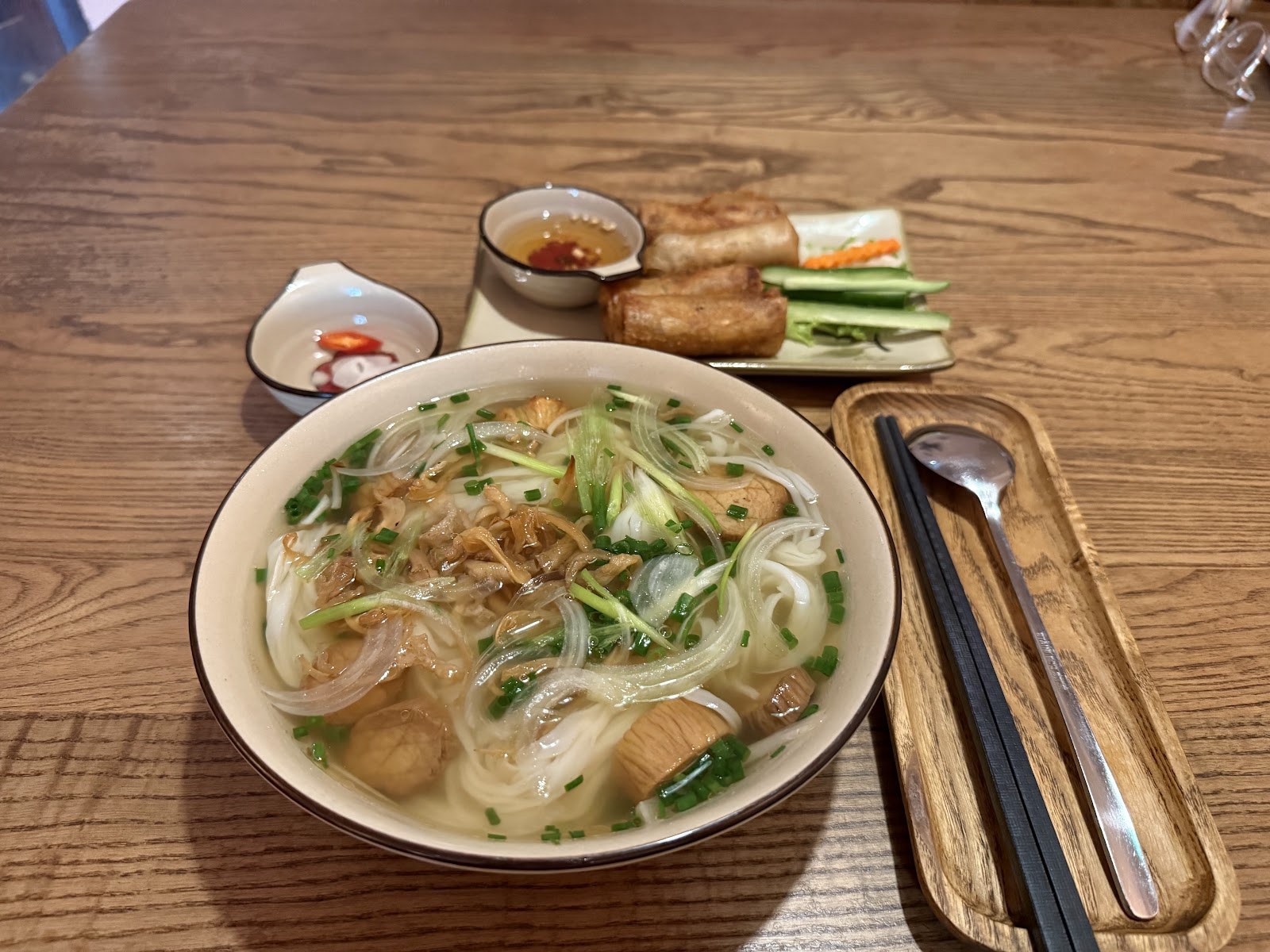 Vegetarian pho with tofu and spring rolls at a chay restaurant