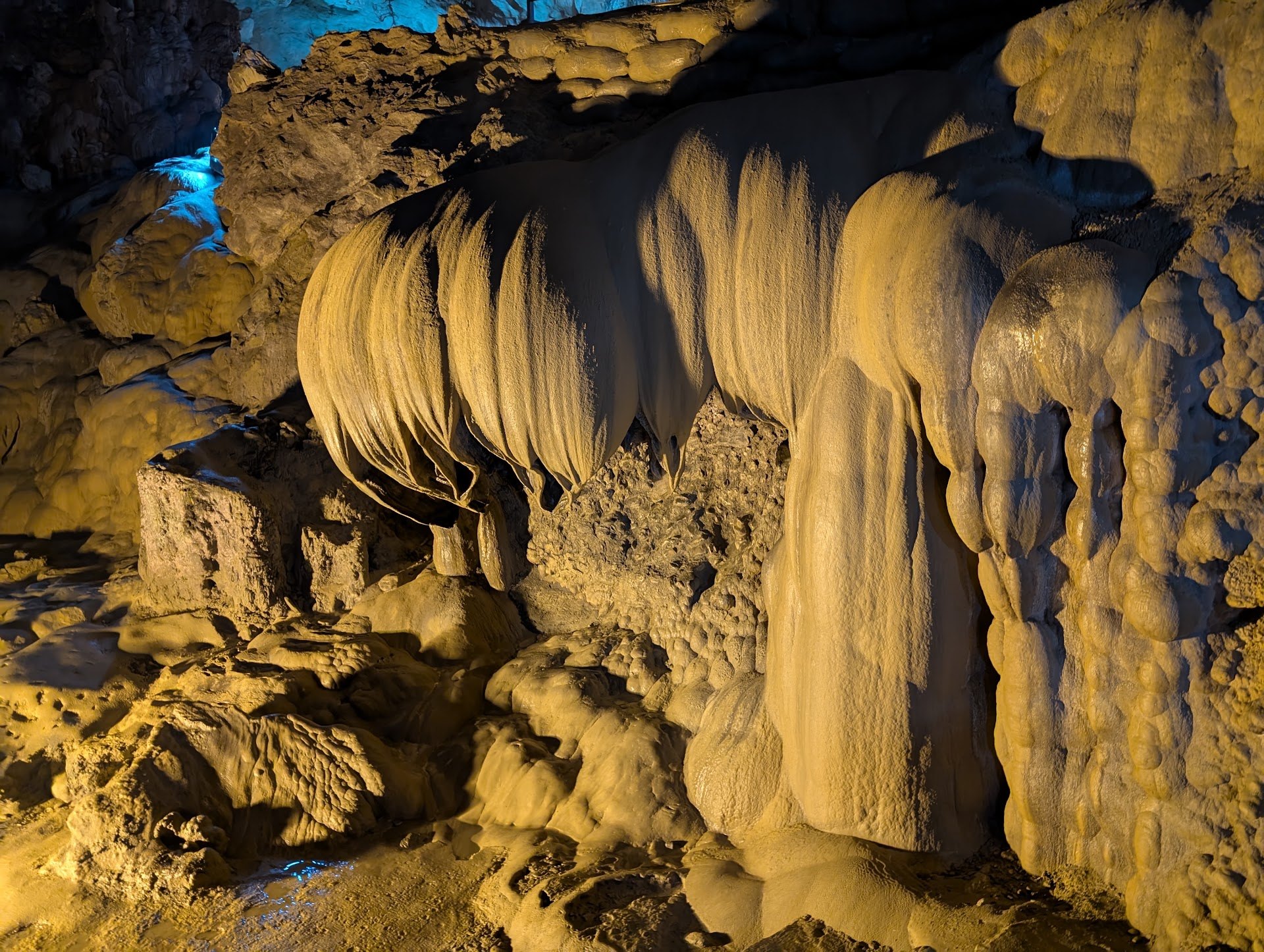 Lit stalactites and flowstone inside Nguom Ngao Cave near Ban Gioc