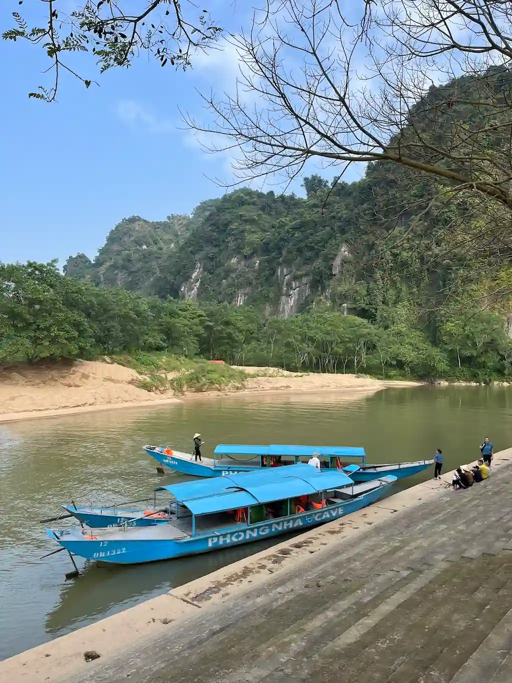 Empty tour boats moored on a swollen Son River at the Phong Nha Cave boat station