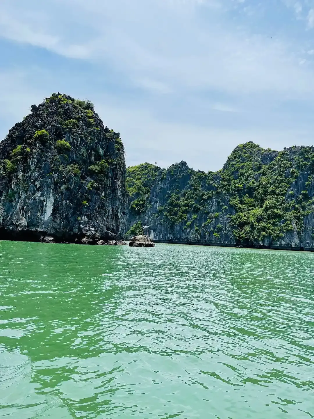 Bright Turquoise Water and Rugged Limestone Islands Under Blue Sky in Lan Ha Bay Vietnam