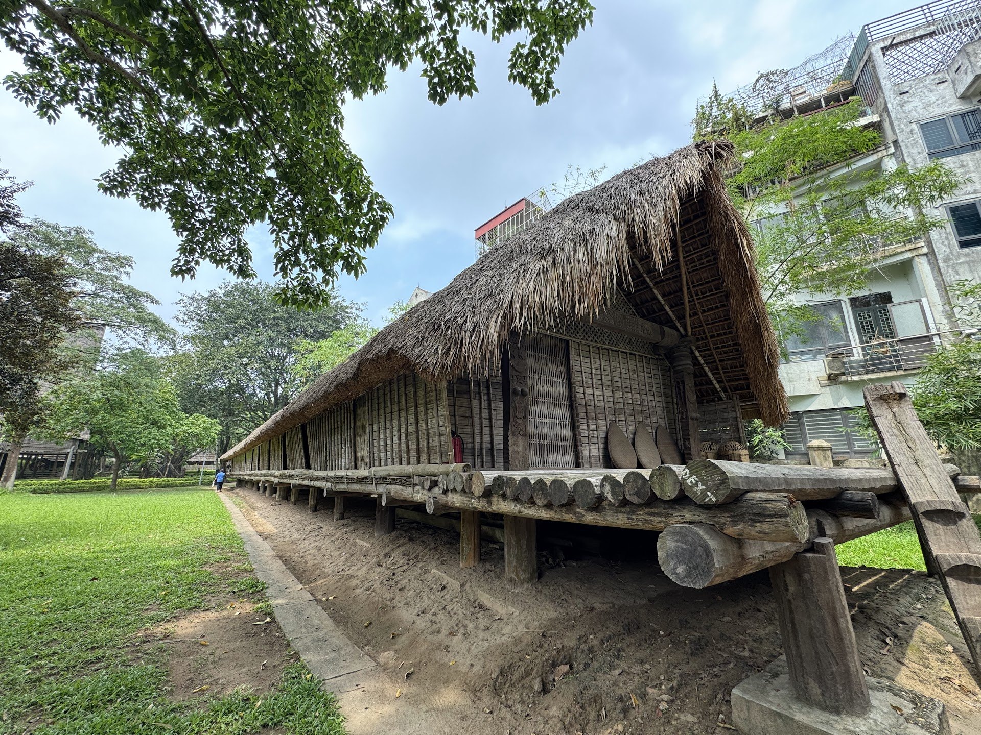 Long thatched house on wooden stilts in the garden of the Museum of Ethnology