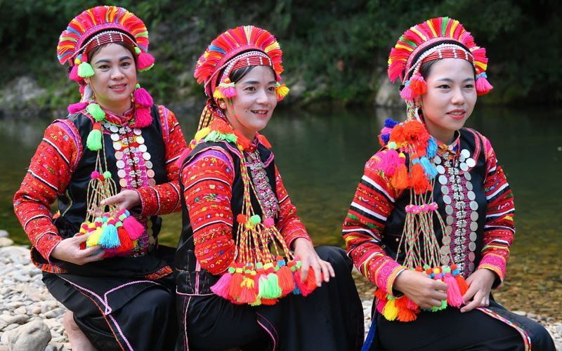 5. Three Women Dressed in Traditional Colorful Attire From a Vietnamese Ethnic Group.
