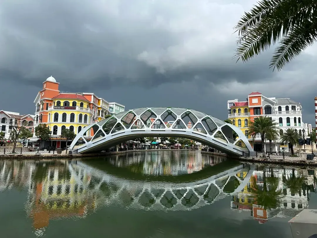 Arched Bridge Over the Venice Canal With Colourful Buildings at Grand World Phu Quoc