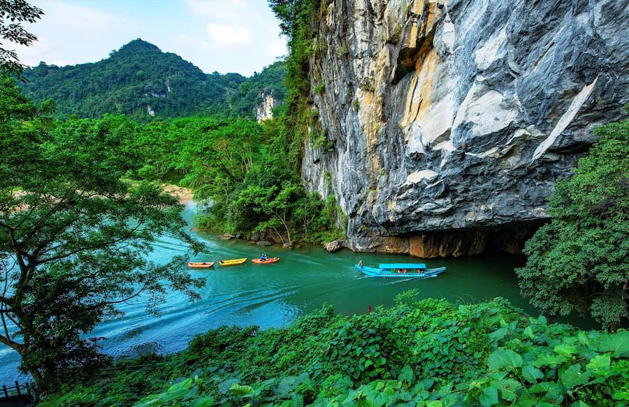 2. Scenic Boat Ride Into Phong Nha Cave With a Lush Green Landscape