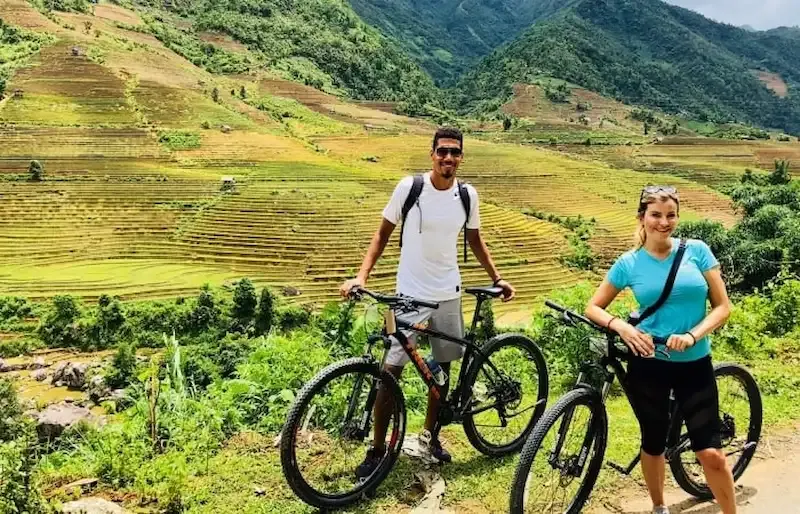 Biking in Muong Hoa Valley with rice terrace in background