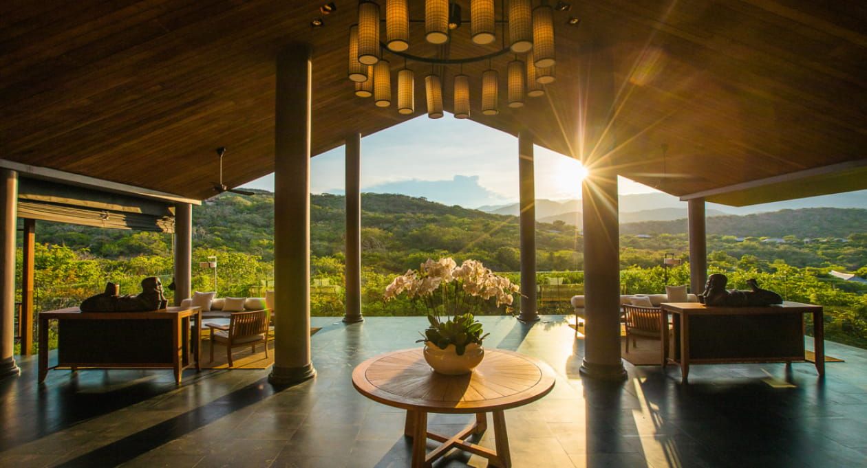 4. a Serene Resort Located in the Hills of Vietnam, Viewed From a Shaded Pavilion at Sunset.