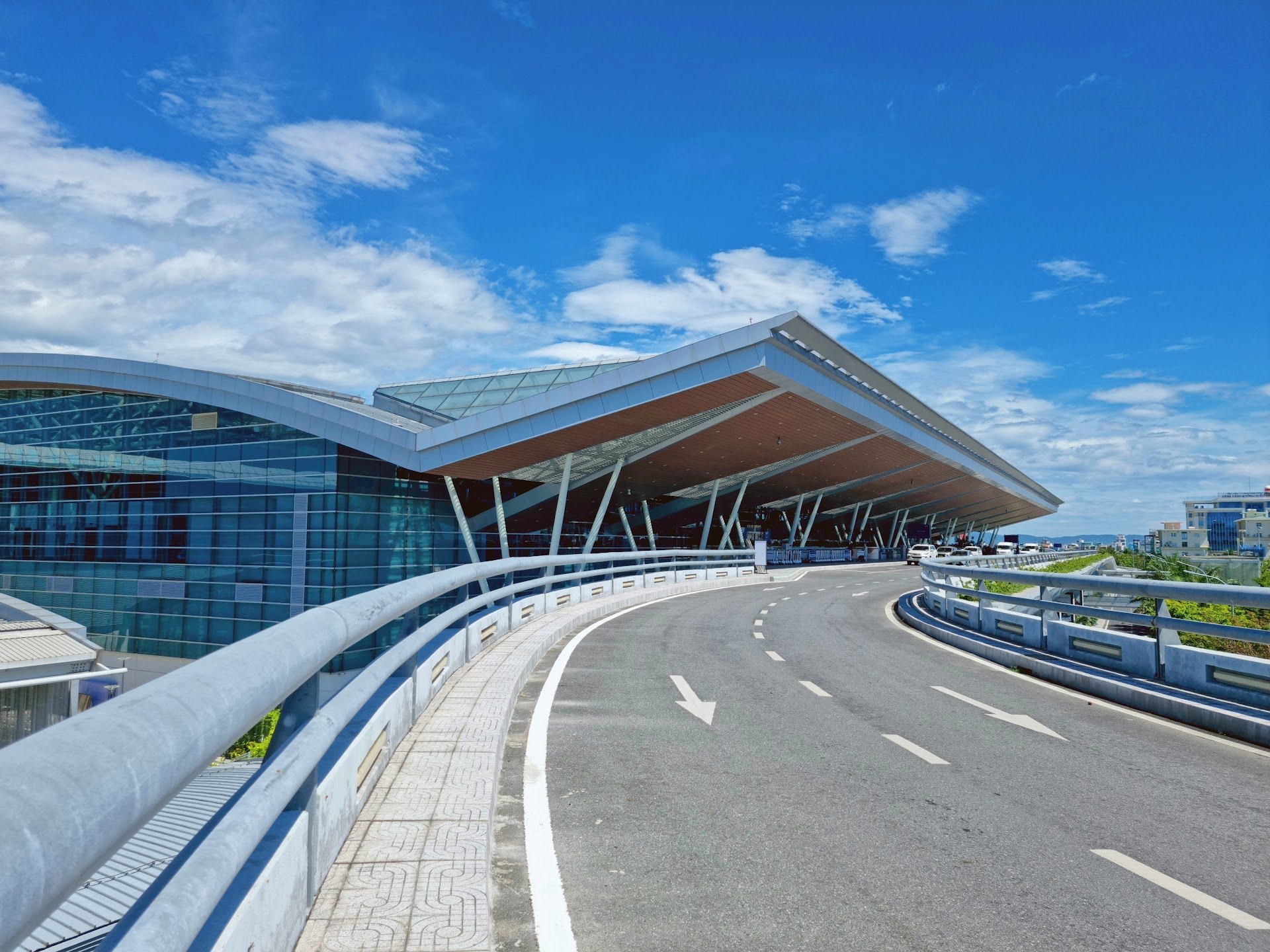 Curved roof of the terminal at Da Nang International Airport beside the departures road
