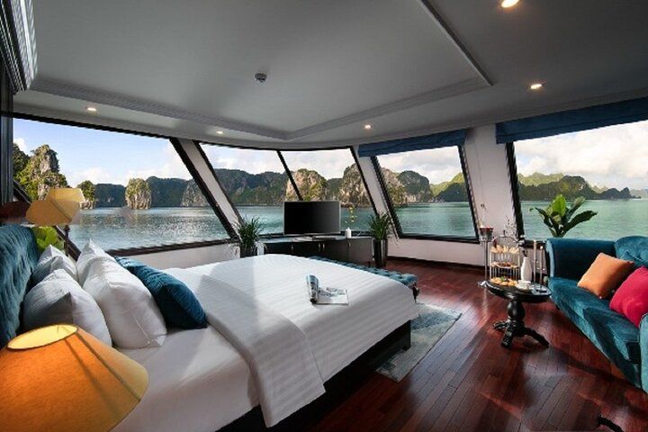 3. a Luxurious Bedroom With Panoramic Windows Offering a Stunning View of Halong Bay.