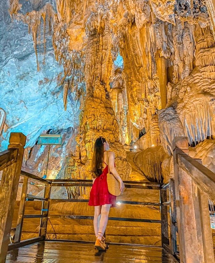 3. Tourist Admiring the Stunning Stalactites Inside Phong Nha Cave.