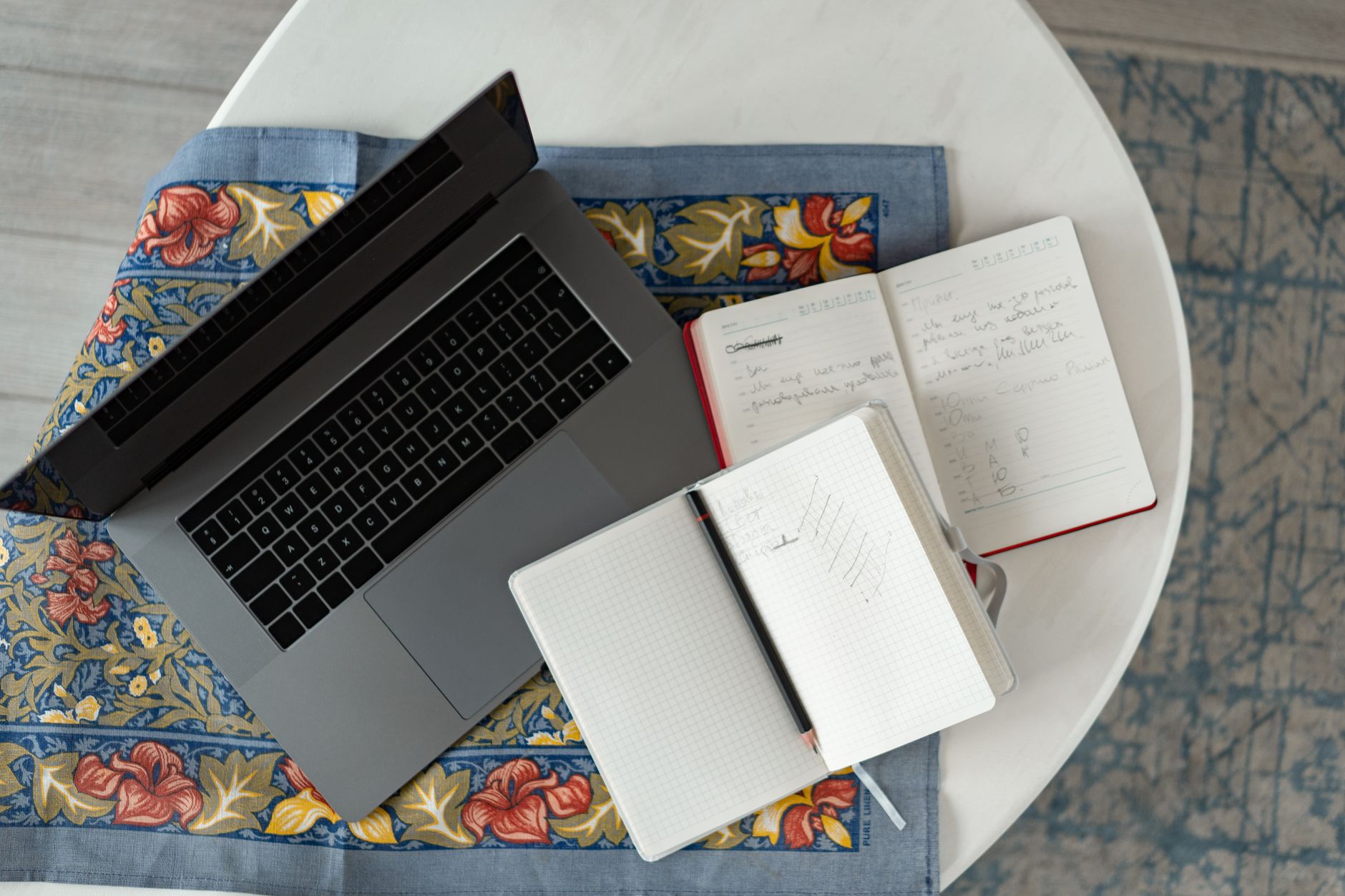Laptop showing a tour booking page beside cash and a notebook on a desk