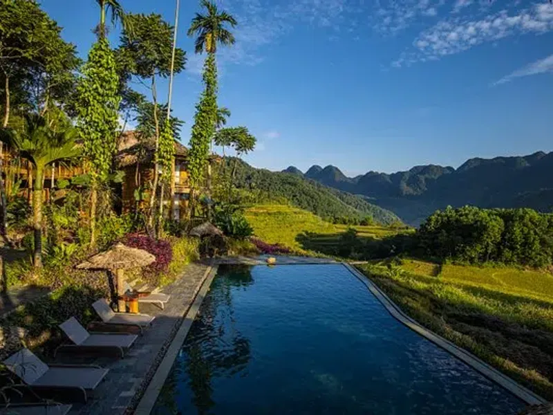 Infinity pool overlooking terraced rice fields and karst limestone mountains at eco lodge in Pu Luong Nature Reserve Thanh Hoa Vietnam