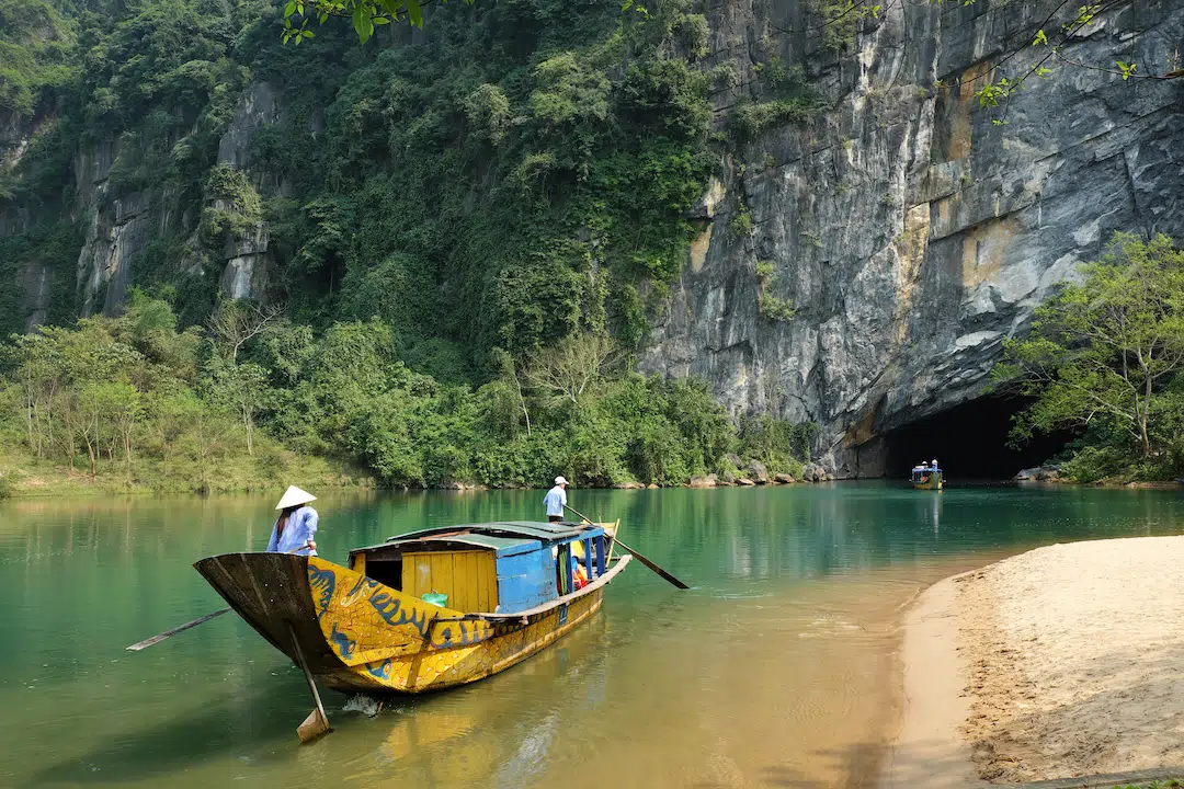 Tour boats on the Son River heading for Phong Nha Cave