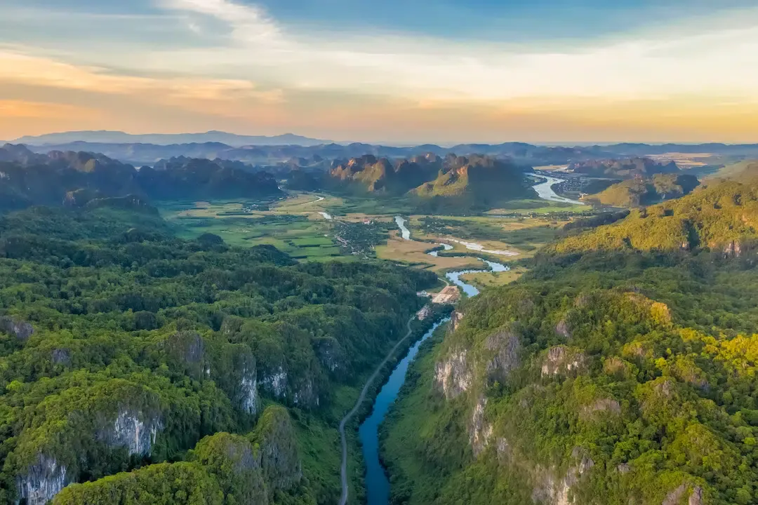 aerial sunset view of the son river winding through the limestone karst mountains of phong nha ke bang national park in vietnam