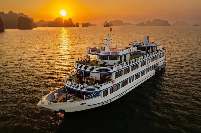 Premium Luxury Cruise Ship With Elegant White Hull Anchored in Turquoise Waters of Bai Tu Long Bay   Modern Cruise Vessel for 2 Night Bay Exploration