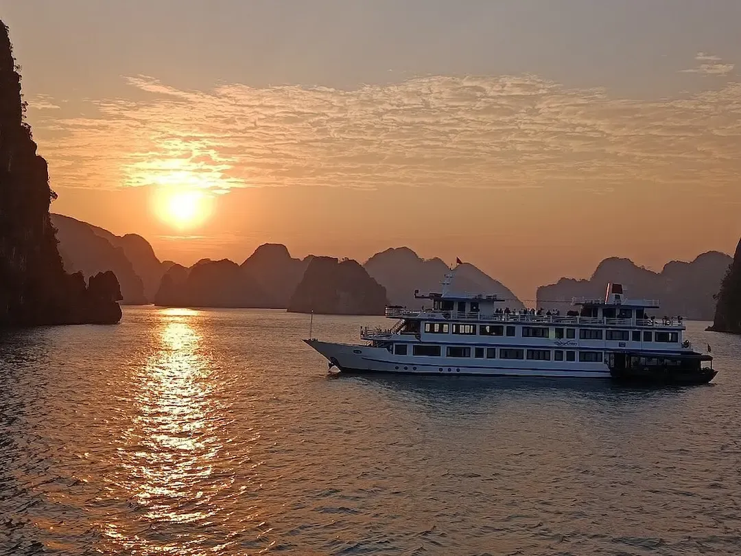 Aerial View of Bai Tu Long Bay Showing Pristine Emerald Waters, Multiple Limestone Island Formations, Traditional Boats, and Lush Tropical Vegetation   Less Crowded Than Ha Long