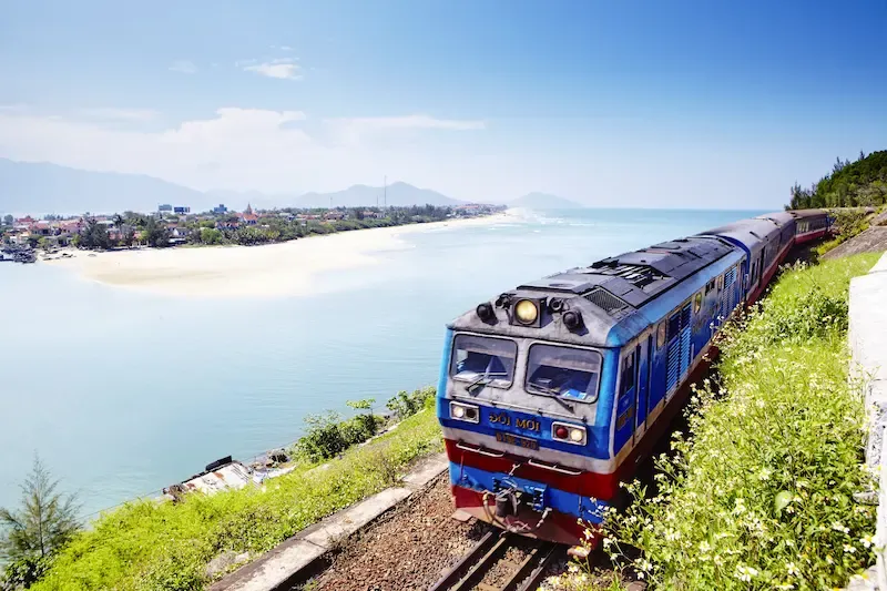 Reunification Express Train Running Along the Ocean in Vietnam