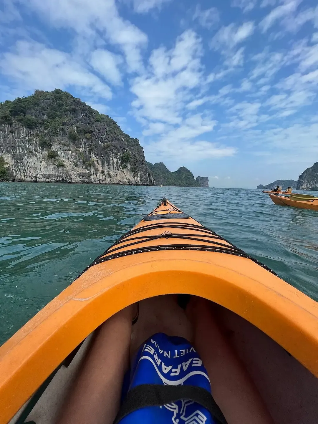 First Person Pov From Orange Kayak Exploring Bai Tu Long Bay With Dramatic Limestone Cliffs and Turquoise Water   Immersive Kayaking Adventure Experience