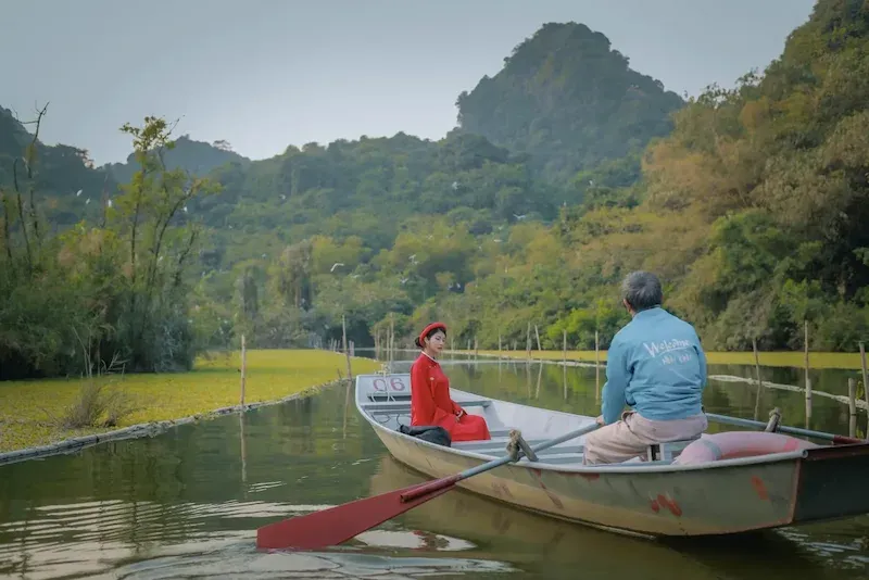 a Tourist Posing for a Picture While on a Boat Tour in Thung Nham