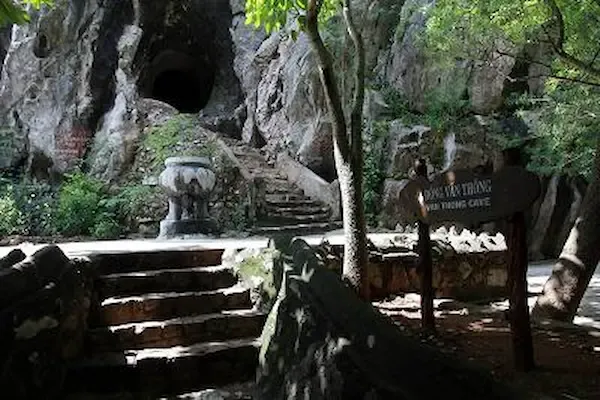 Van Thong Cave in Marble Mountains Da Nang featuring Buddha statue in main chamber with natural Heaven Gate opening and sky-lit ceiling hole
