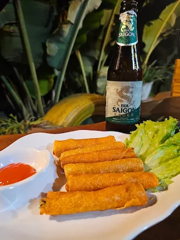 Spring rolls and cold beer at Friendly Garden Restaurant with fresh ingredients and traditional Vietnamese food at Phong Nha