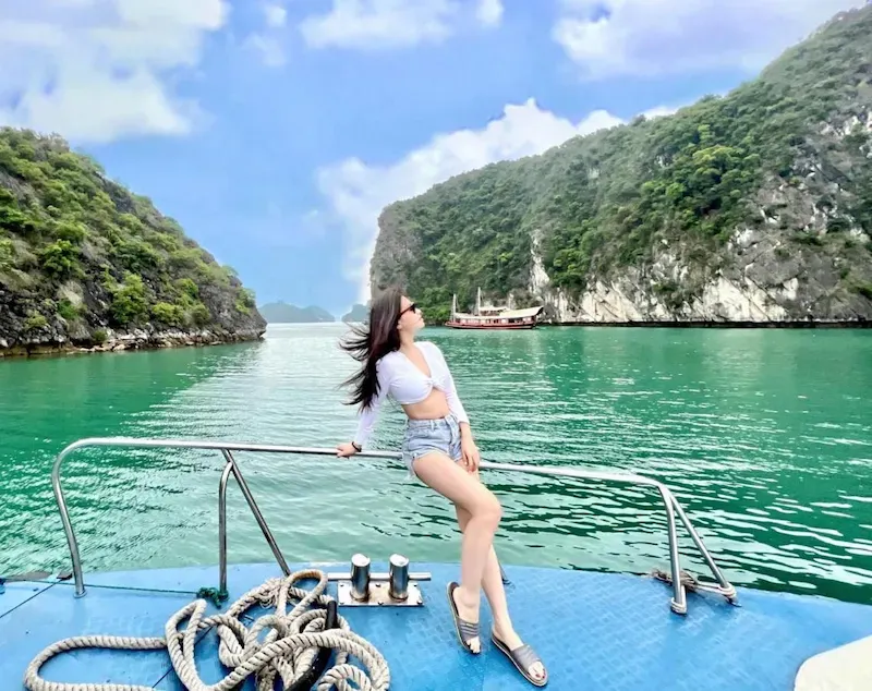 Tourist Posing on a Cruise Tour With Lan Ha Bay in Background