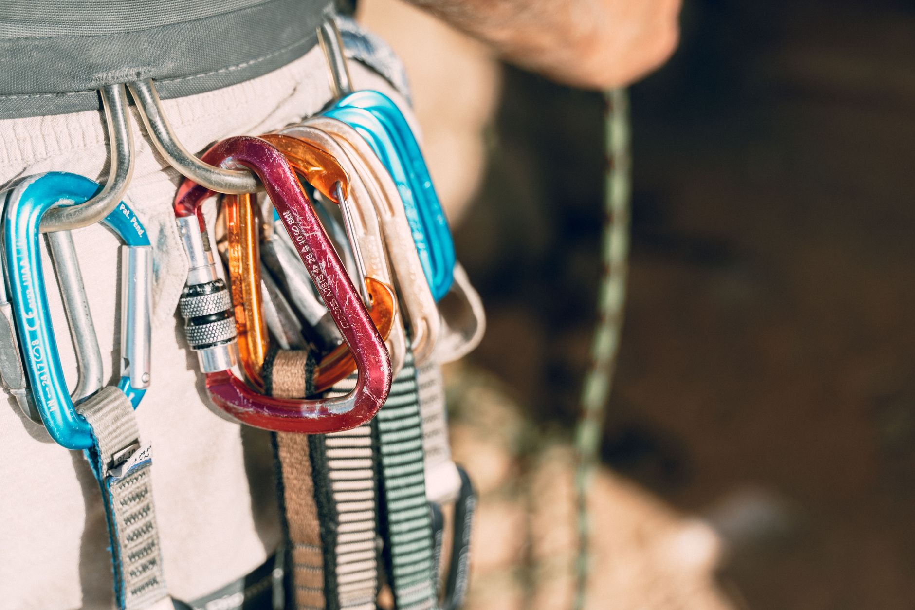Carabiners and slings clipped to a climbing rope