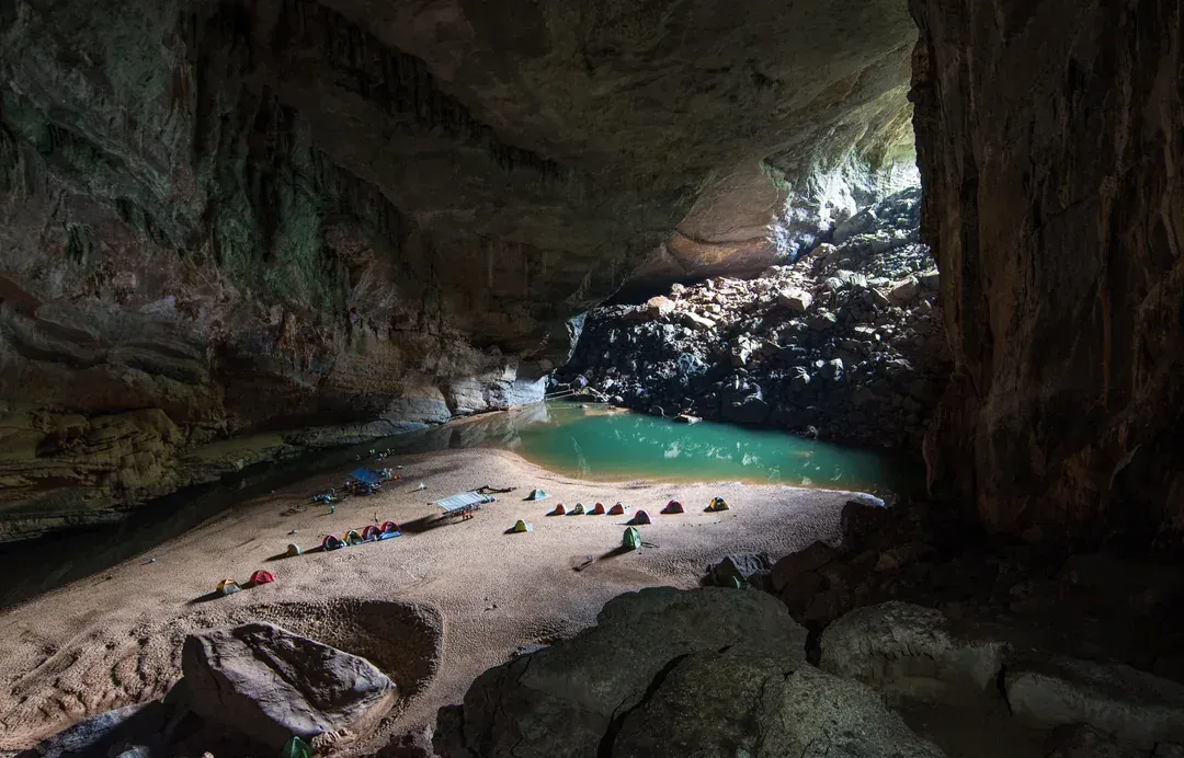 Son Doong Cave expedition showing massive chamber with jungle, underground river inside world's largest cave Vietnam