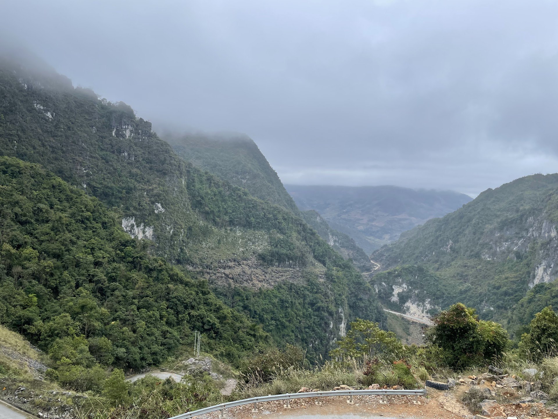 Mist over steep forested limestone valleys from the Khau Coc Cha Pass road