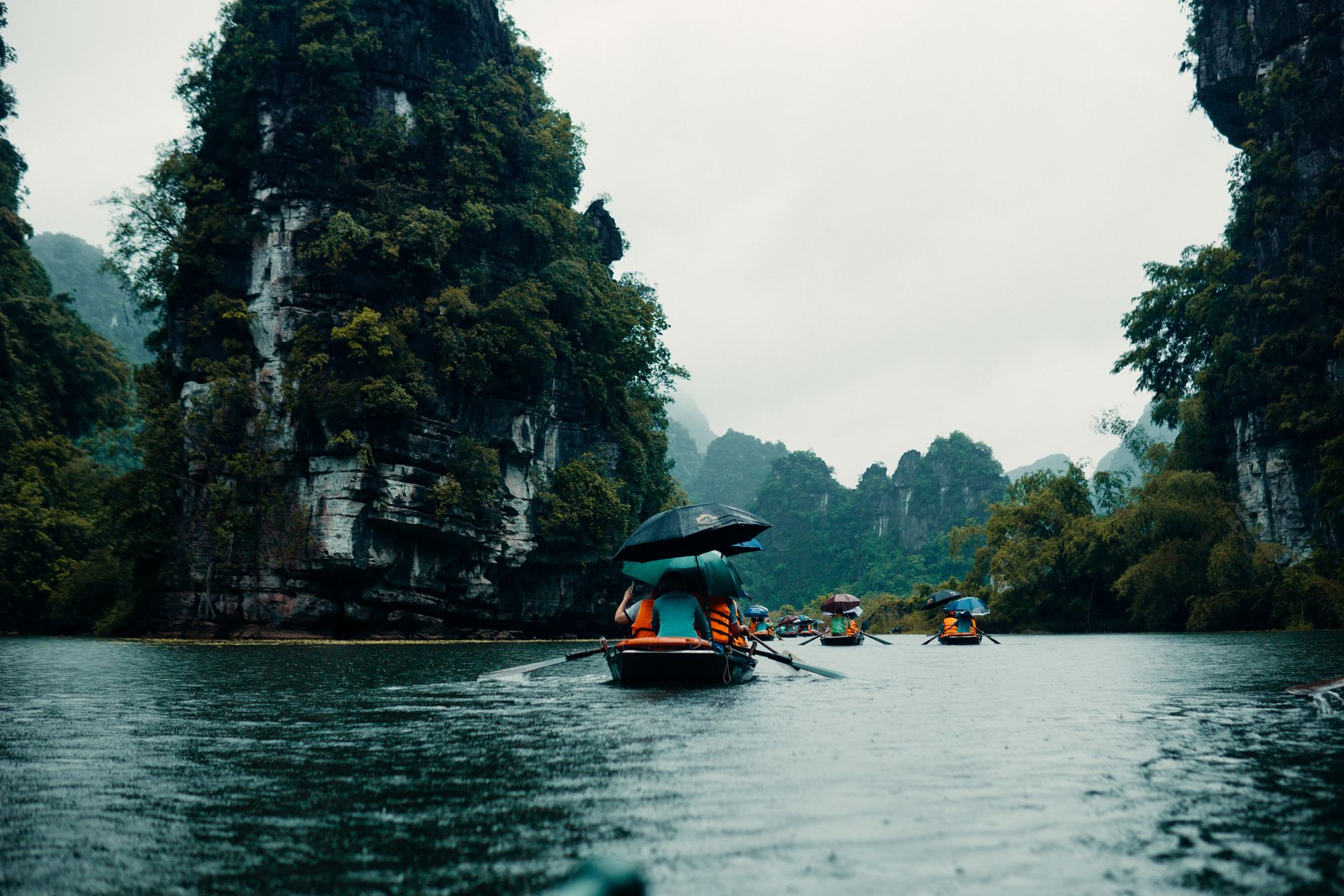 Heavy rain falling on a river below jungle-covered karst in central Vietnam