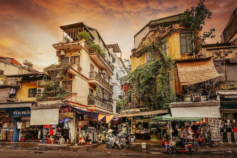 Ochre shopfronts and lanterns in a Vietnamese old town at dusk