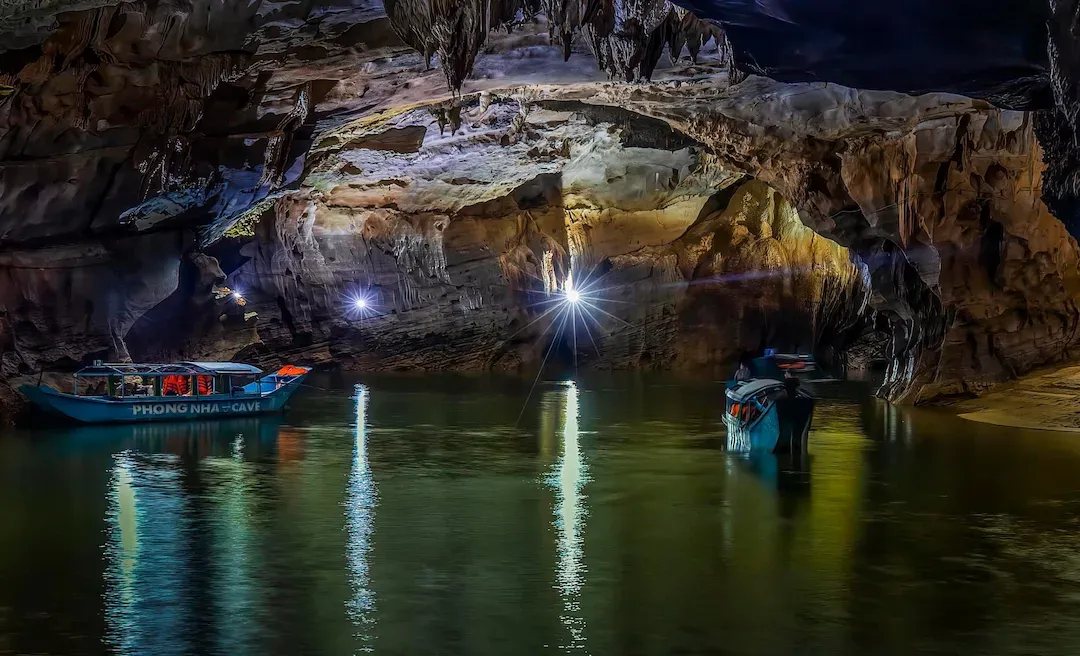 Phong Nha Cave boat tour with illuminated stalactites on Son River