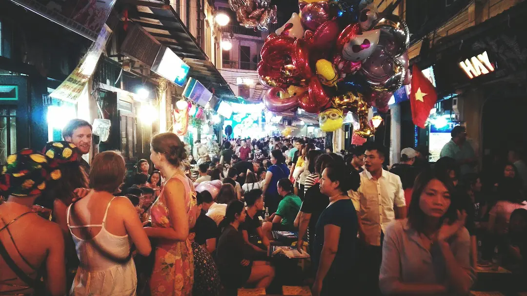 Evening crowd filling a narrow street in Hanoi's Old Quarter