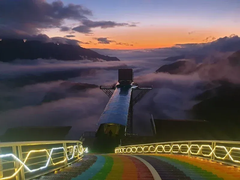 Rainbow Stairs and Illuminated Handrails Descending to the Glass Bridge Platform at Sunset, Sapa
