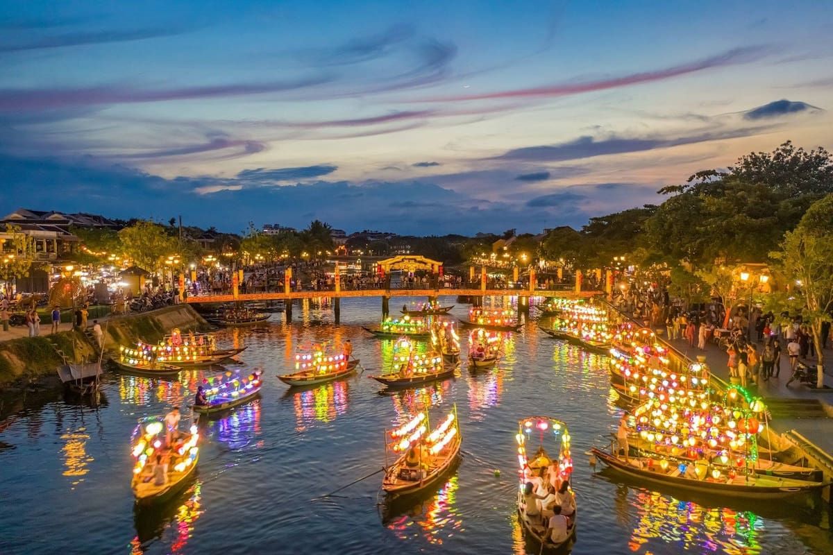 2. Boats Illuminated With Colorful Lanterns Floating on a River During Sunset in Hoi An
