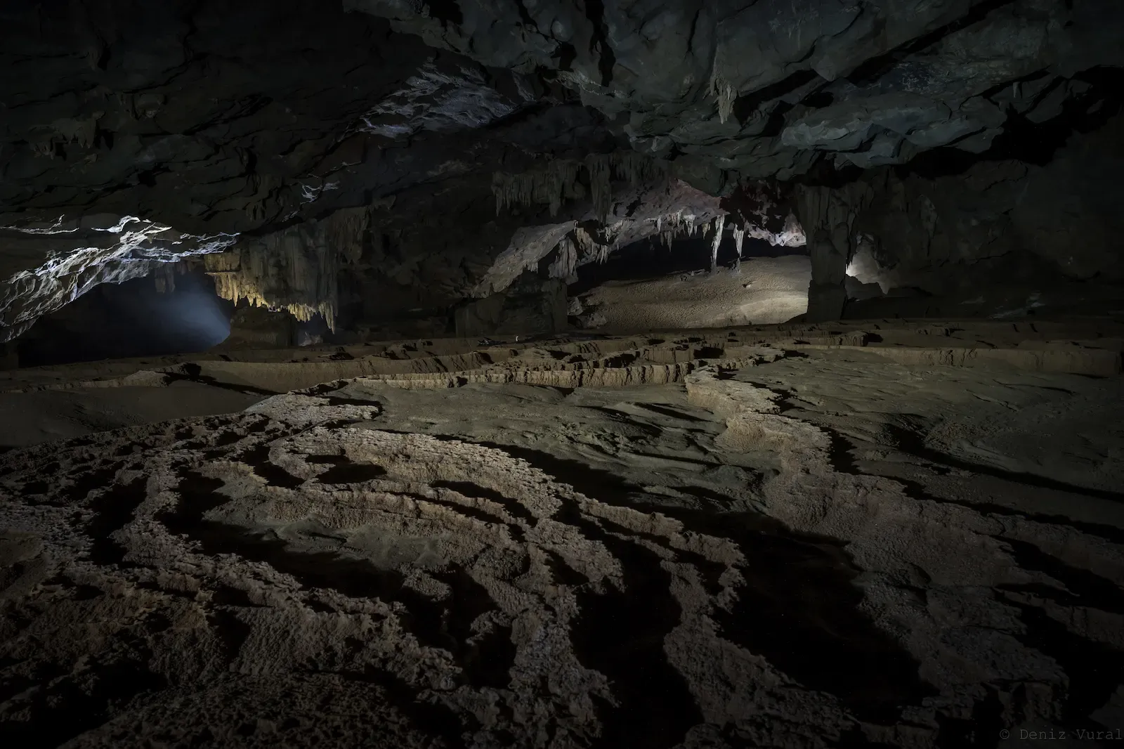 Natural rimstone pools and calcite terraces on the cave floor of the Nuoc Nut Cave trek