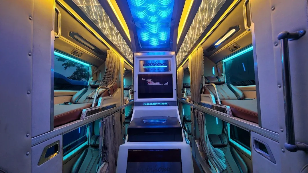 A cabin style berth with a curtain on a Vietnamese sleeper bus