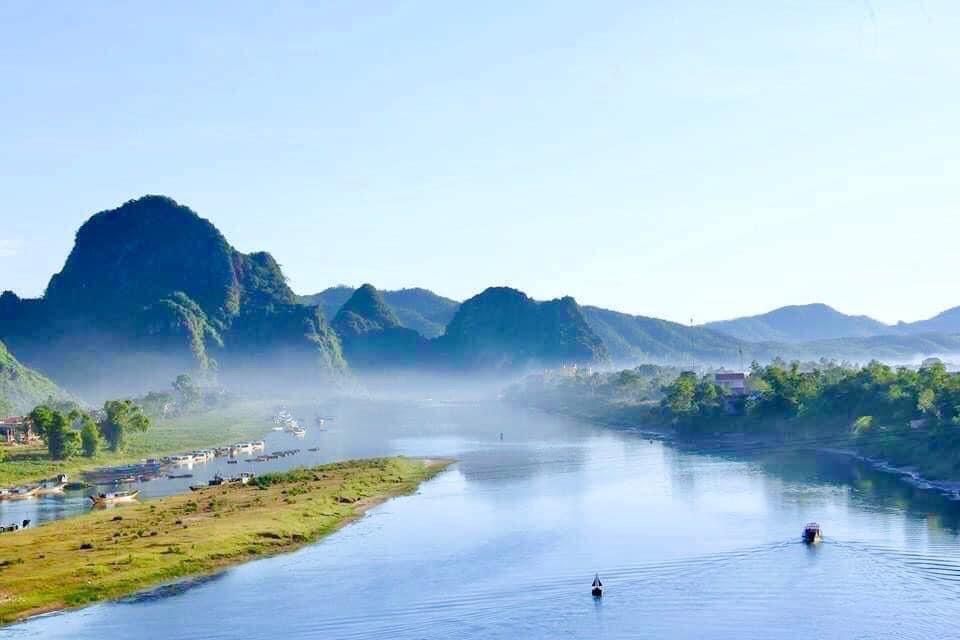 3. Scenic View of Boats on a River With Limestone Mountains in Phong Nha