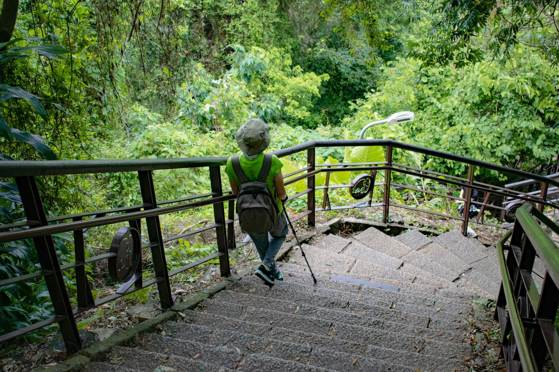 Trekker pausing for breath on a steep jungle trail in Phong Nha