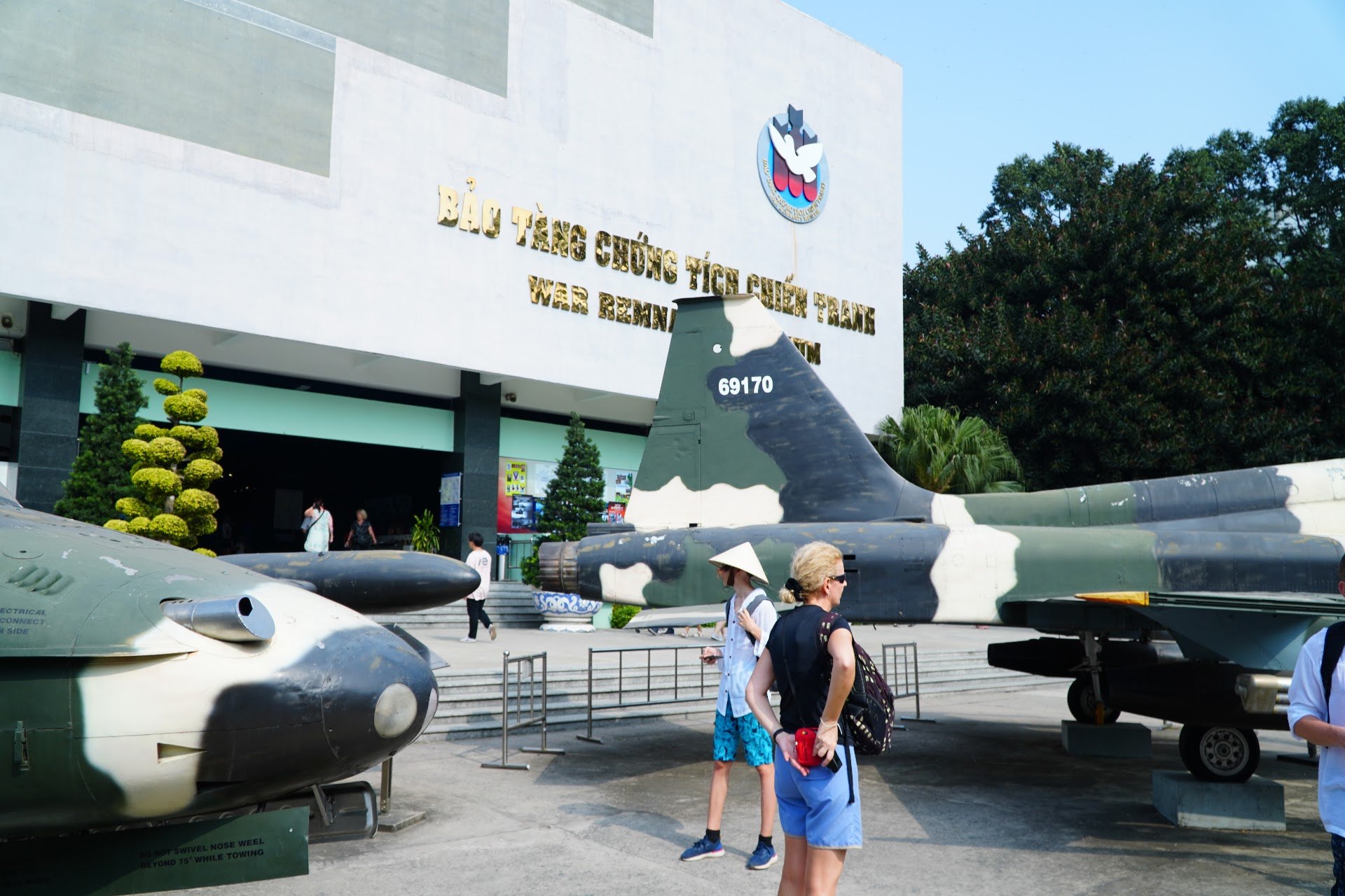 Visitors beside aircraft outside the War Remnants Museum in Ho Chi Minh City