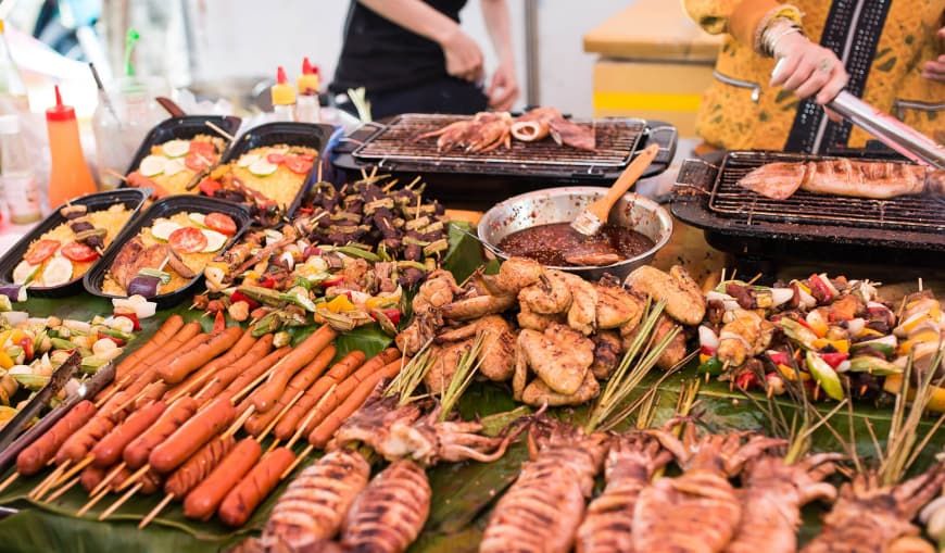 Variety of Grilled Street Food in Vietnam, Including Skewers, Sausages, and Seafood