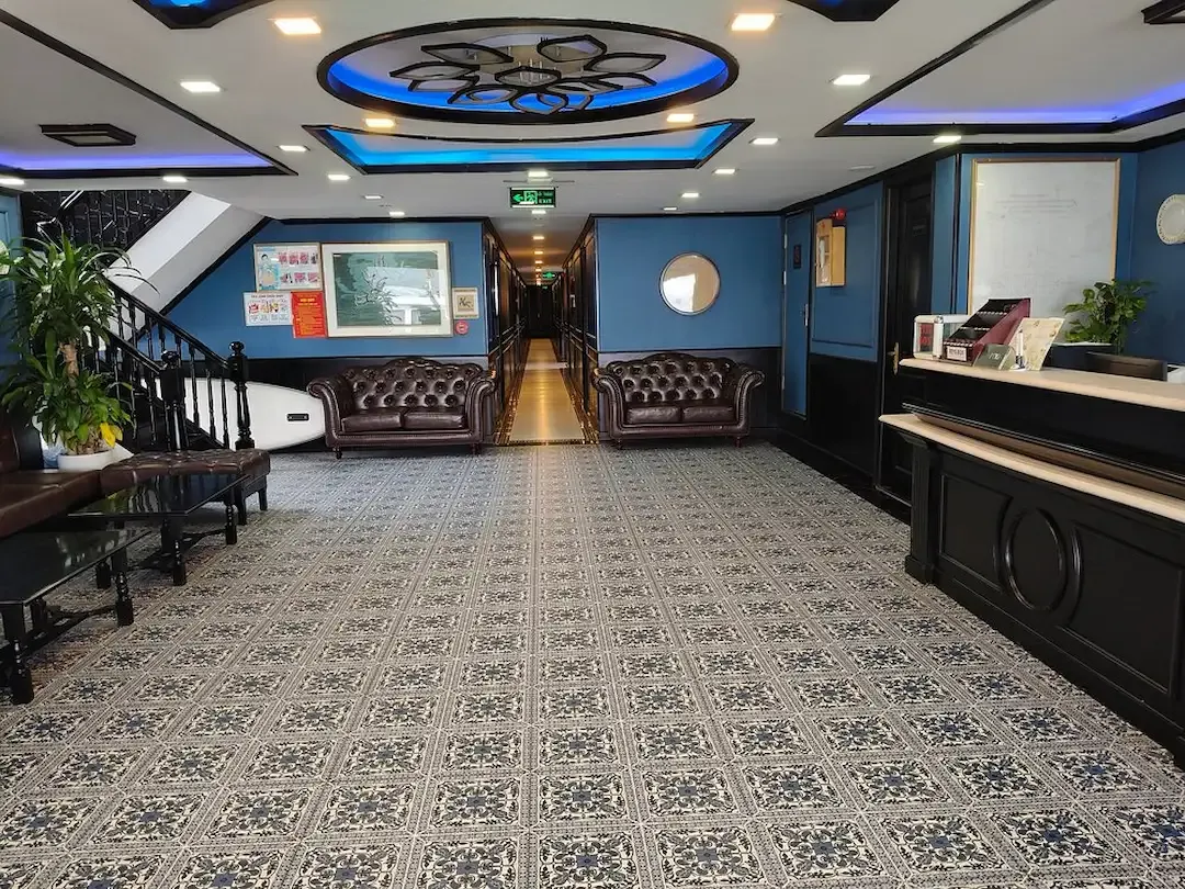 Lobby of Lan Ha Bay Overnight 5 Star Cruise With Patterned Tile Floor Blue Walls and Leather Sofas